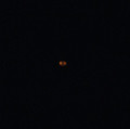 Doughnut shaped light stationary in sky image 976