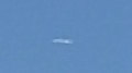 Oval shaped UFO shining or glowing in the sky image 1003