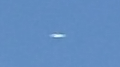 Oval shaped UFO shining or glowing in the sky image 1004