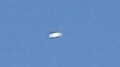 Oval shaped UFO shining or glowing in the sky image 1005