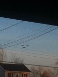3 round ufos in the sky across the road image 433