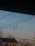 3 round ufos in the sky across the road image 1